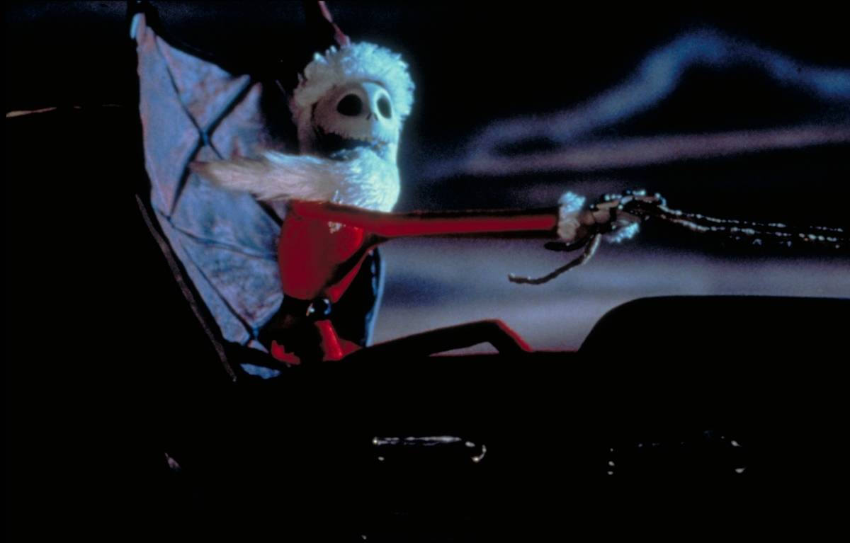 Jack Skellington driving Santa's sleigh with red suit and beard