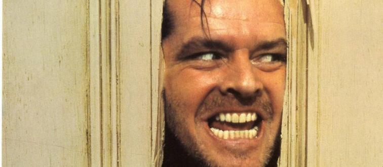 Jack Nicholson poking his face through a broken door as Jack Torrance in The Shining
