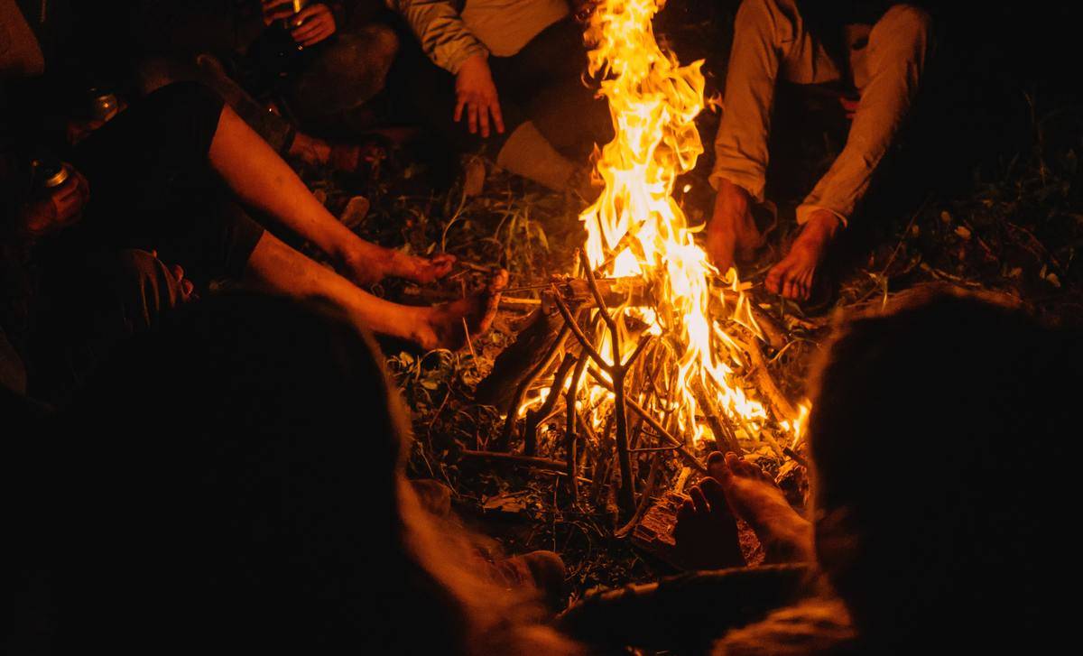 friends gathered around a camp fire