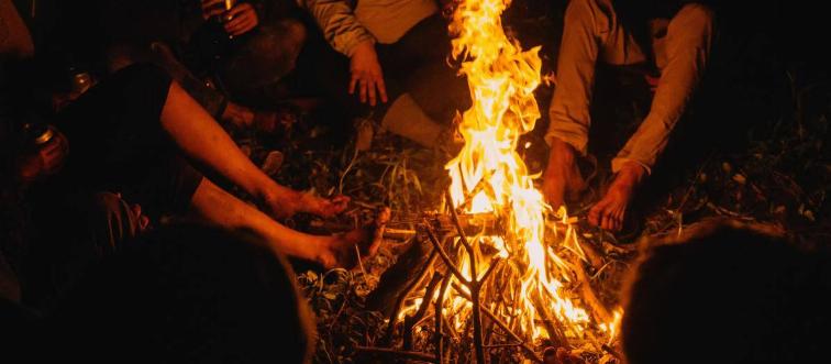friends gathered around a camp fire
