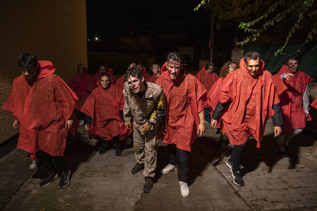 Actors and participants portraying zombies walk the streets looking for  participants during a Survival Zombie contest on November 01, 2022 in El
 Casar, Guadalajara province, Spain.