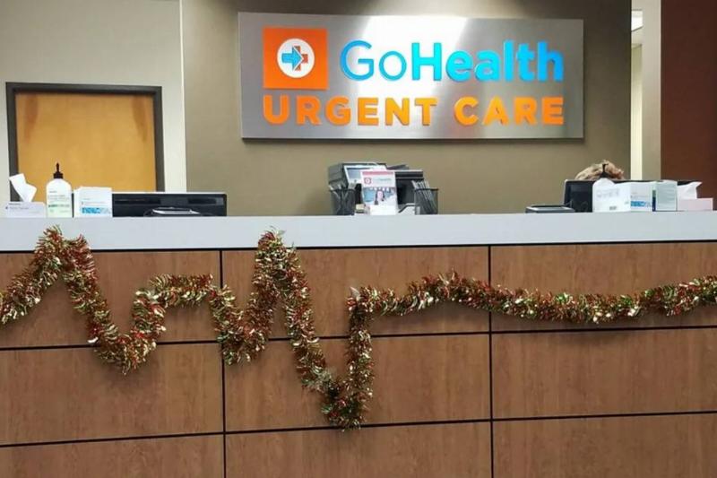 Reception desk at urgent care clinic with colorful Christmas wreath in the shape of heart monitor lines