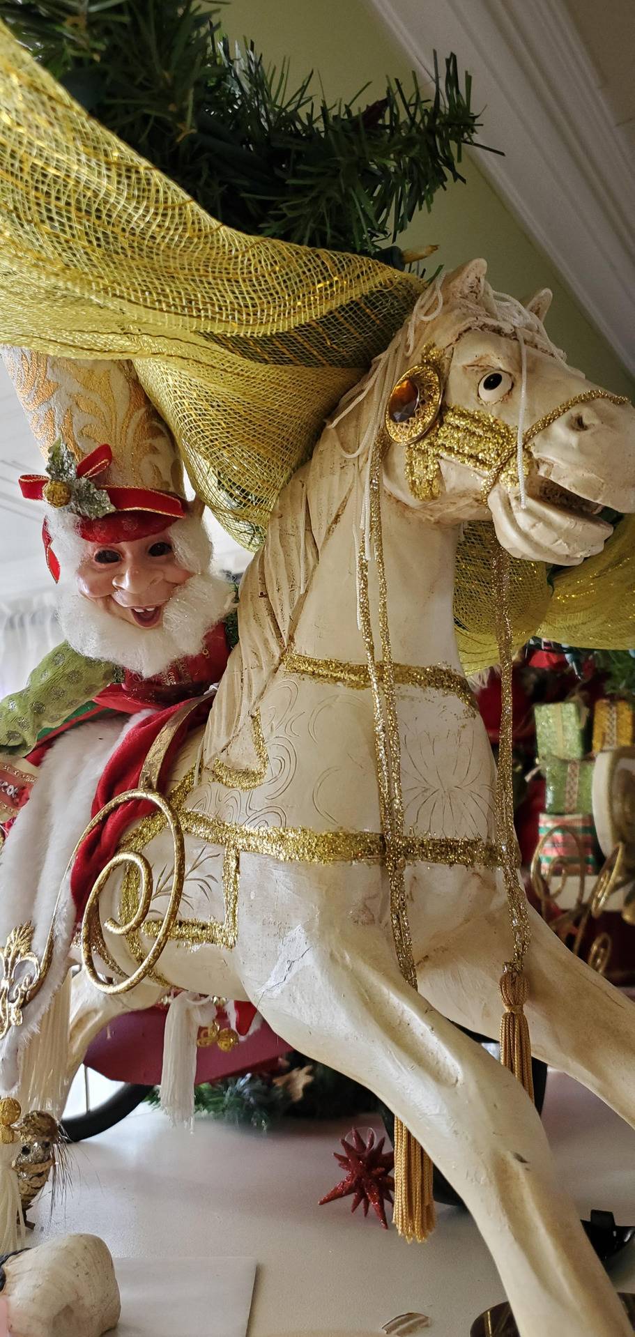 elf figurine with creepy smile riding very angry horse figurine