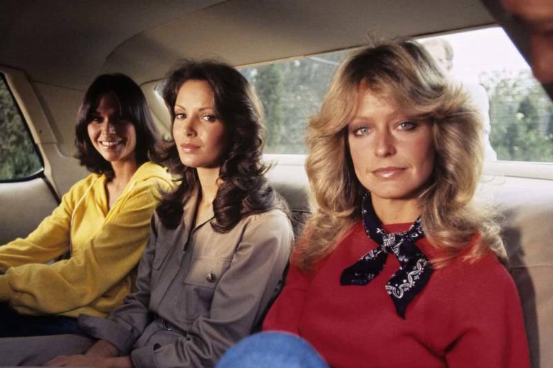 Jaclyn Smith, Kate Jackson and Farrah Fawcett sitting in car's back seat in Charlie's Angels