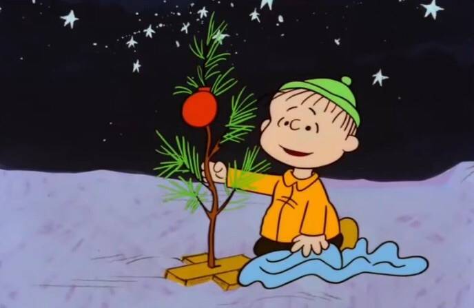 Linus caring for tiny Christmas tree in A Charlie Brown Christmas