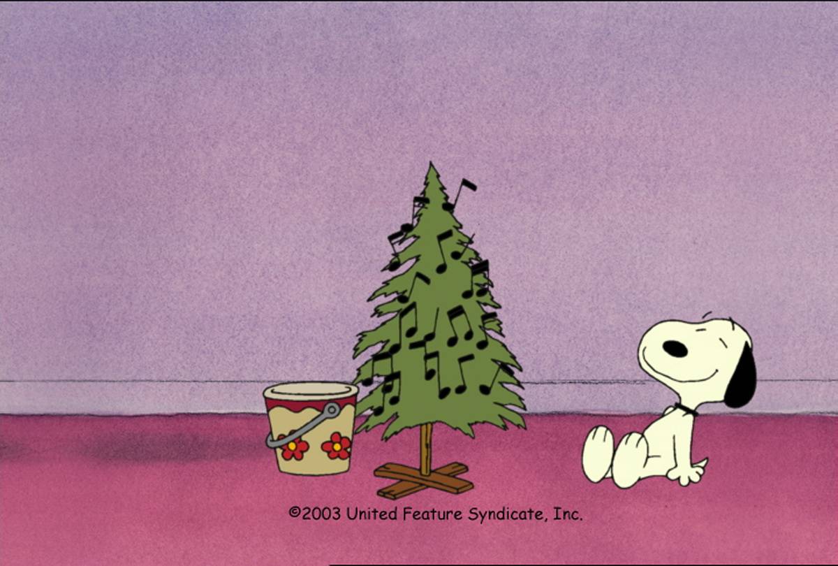 Snoopy sitting next to Christmas tree in I Want A Dog For Christmas Charlie Brown