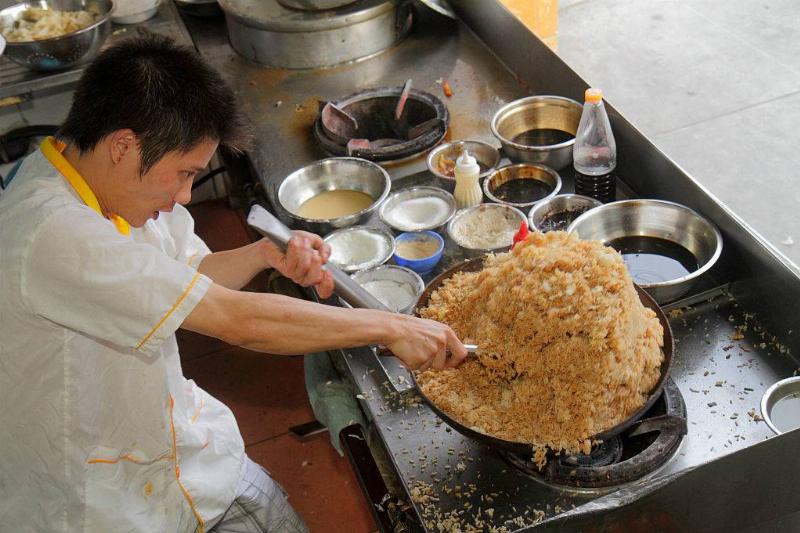 brown rice 614266850 chef cooking brown rice on a wok burner