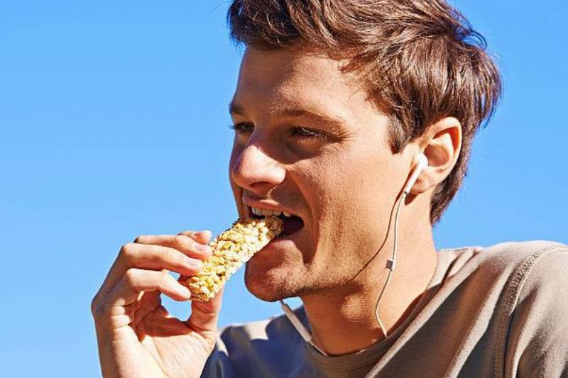 granola bar 586119048 guy eating a granola bar