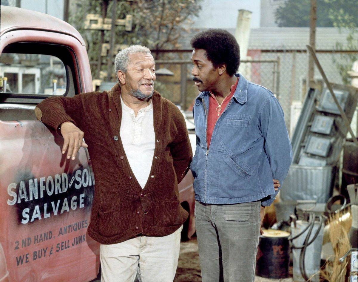 Redd Foxx and Demond Wilson next to branded pickup truck in Sanford and Son