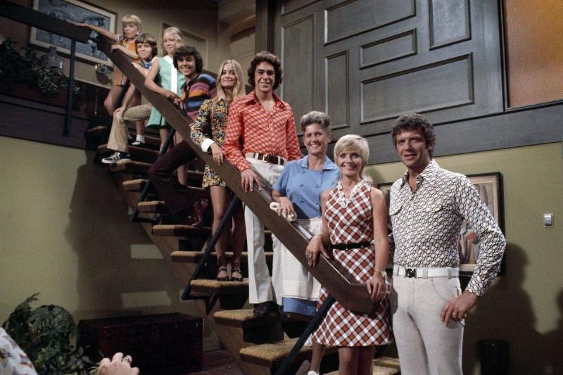 the cast of The Brady Bunch standing on staircase