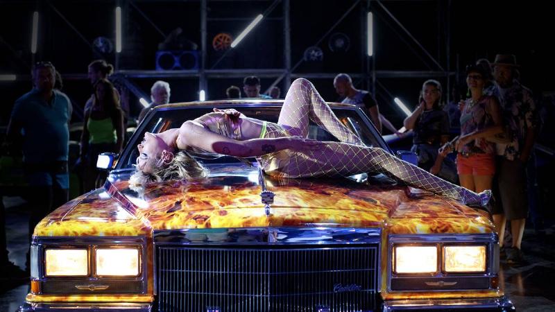 titane_VF6KKr woman dancing in bikini on a cadillac