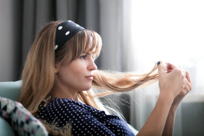 woman-at-home-looking-at-her-hair-checking-hair-c-2021-08-30-00-08-32-utc