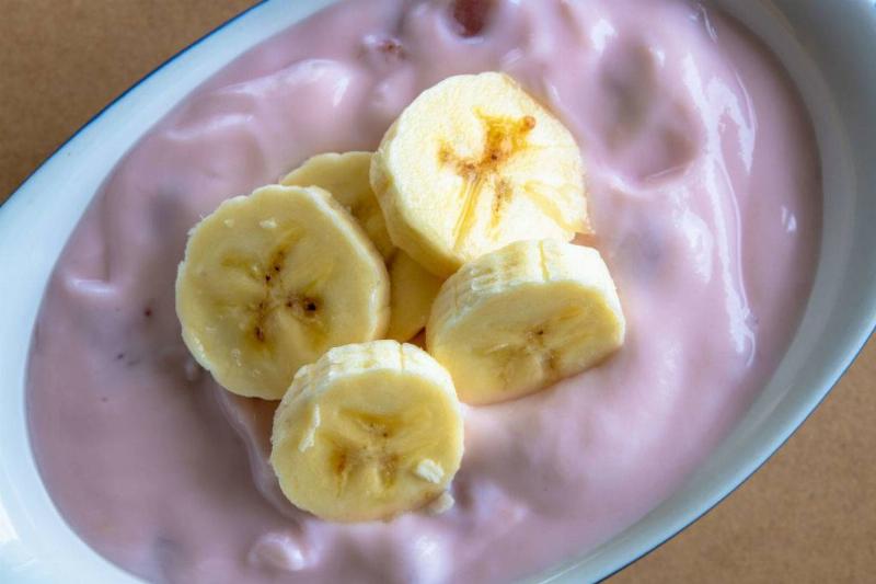 yogurt 1067094934 strawberry yogurt with pieces of ripe banana on top