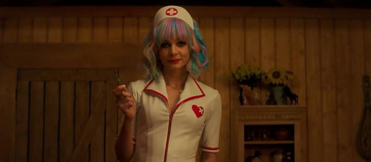 Carey Mulligan standing in nurse costume and multi-colored hair in Promising Young Woman