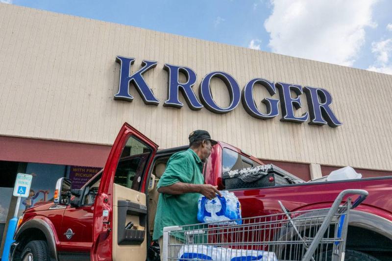 kroger 1422290450 A customer loads his truck after shopping at a Kroger grocery store