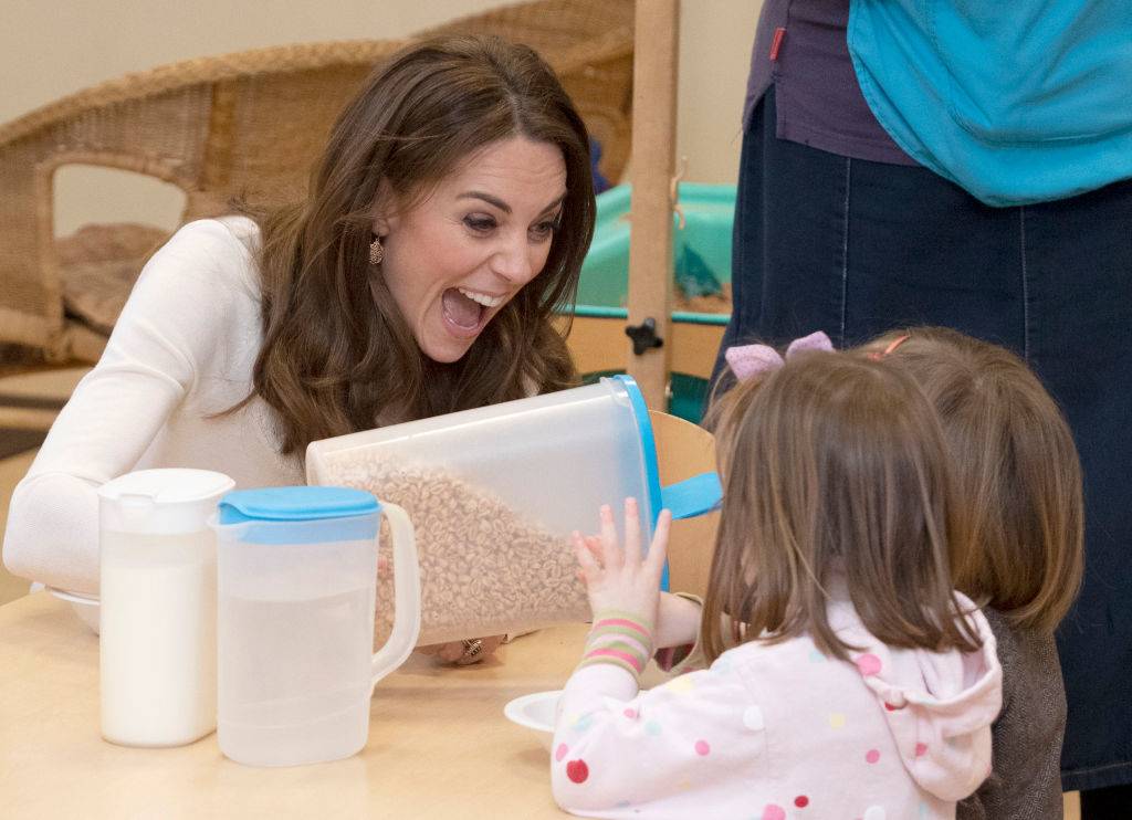 kate handing out cereal to little girls