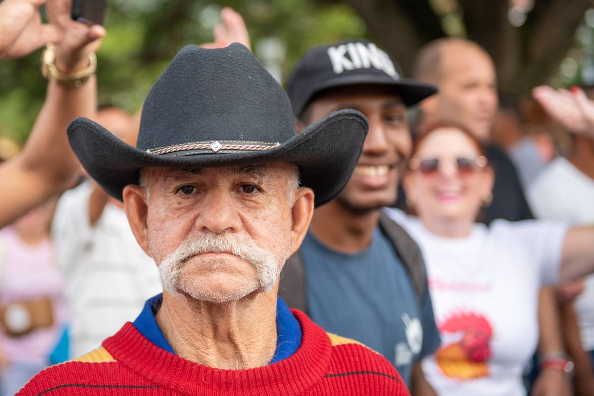 Cuban senior man with moustache and hat enjoying 'Las Parrandas' which is a traditional festival in the colonial village