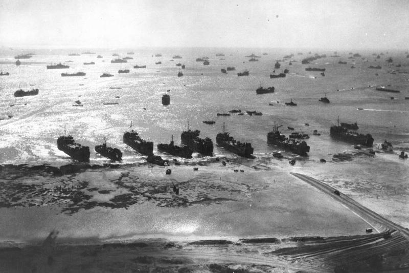 American warships protect troops during a World War II beach landing, Okinawa, Japan, 1945.
