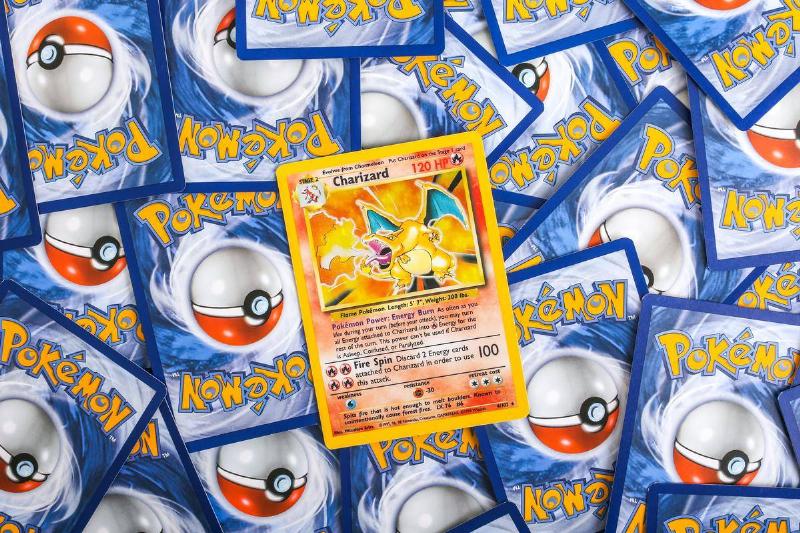 Charizard card sitting on pile of Pokemon cards