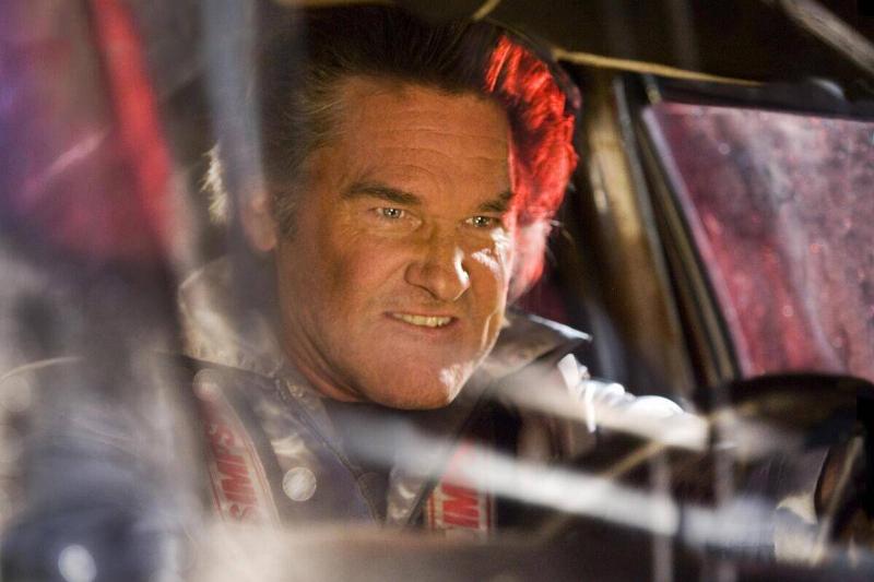 Kurt Russell driving with evil facial expression as Stuntman Mike in Death Proof