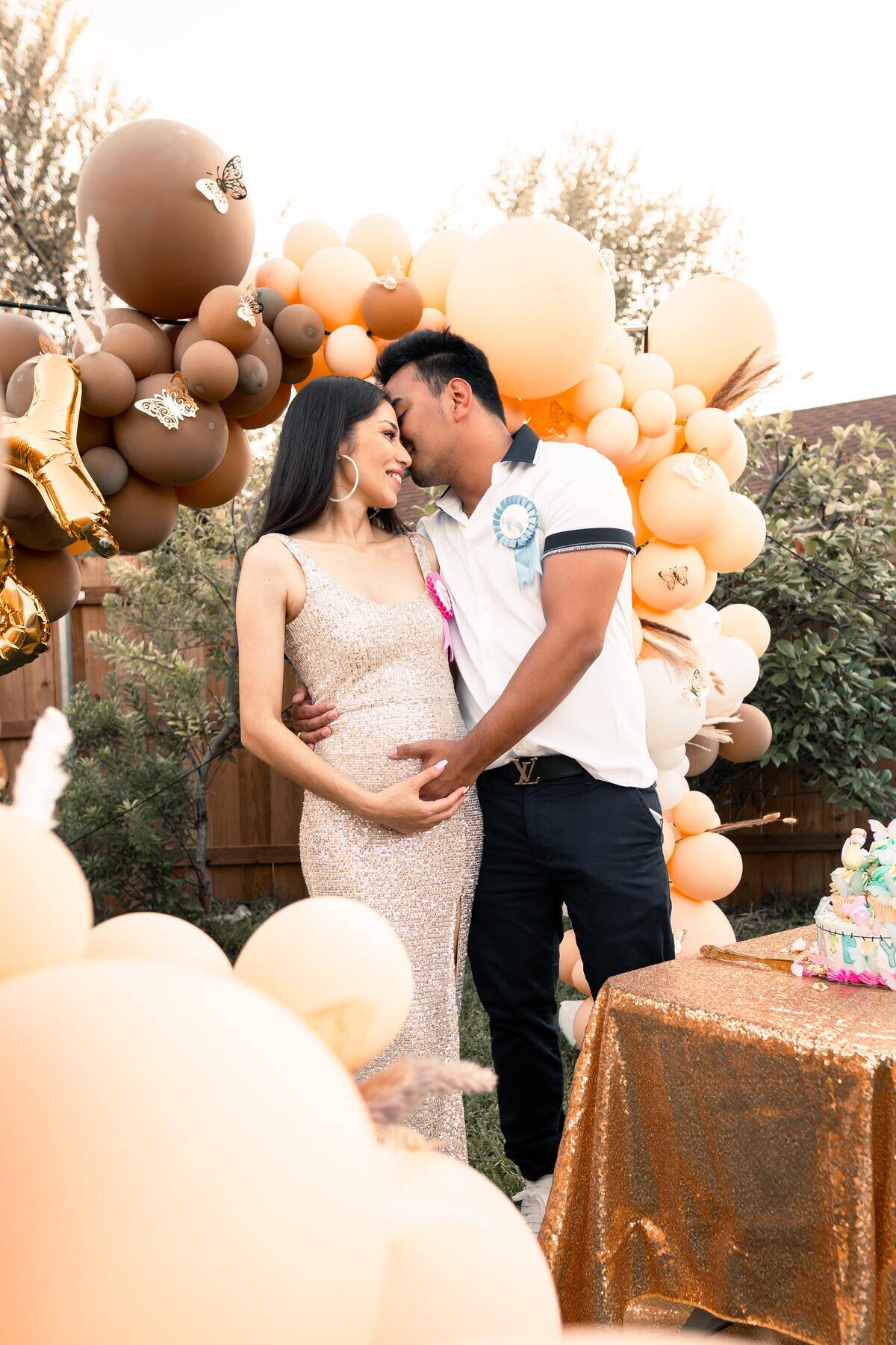 Man embraces pregnant woman at gender reveal party