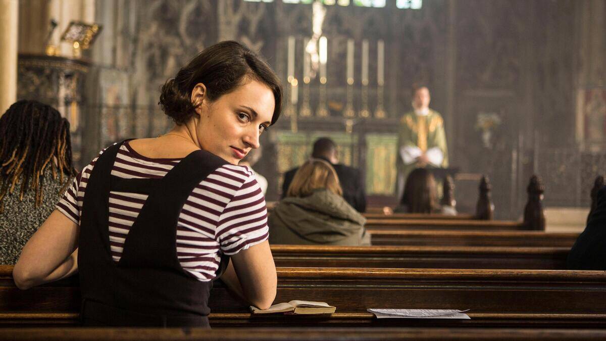 Phoebe Waller-Bridge looking back from church pew in Fleabag