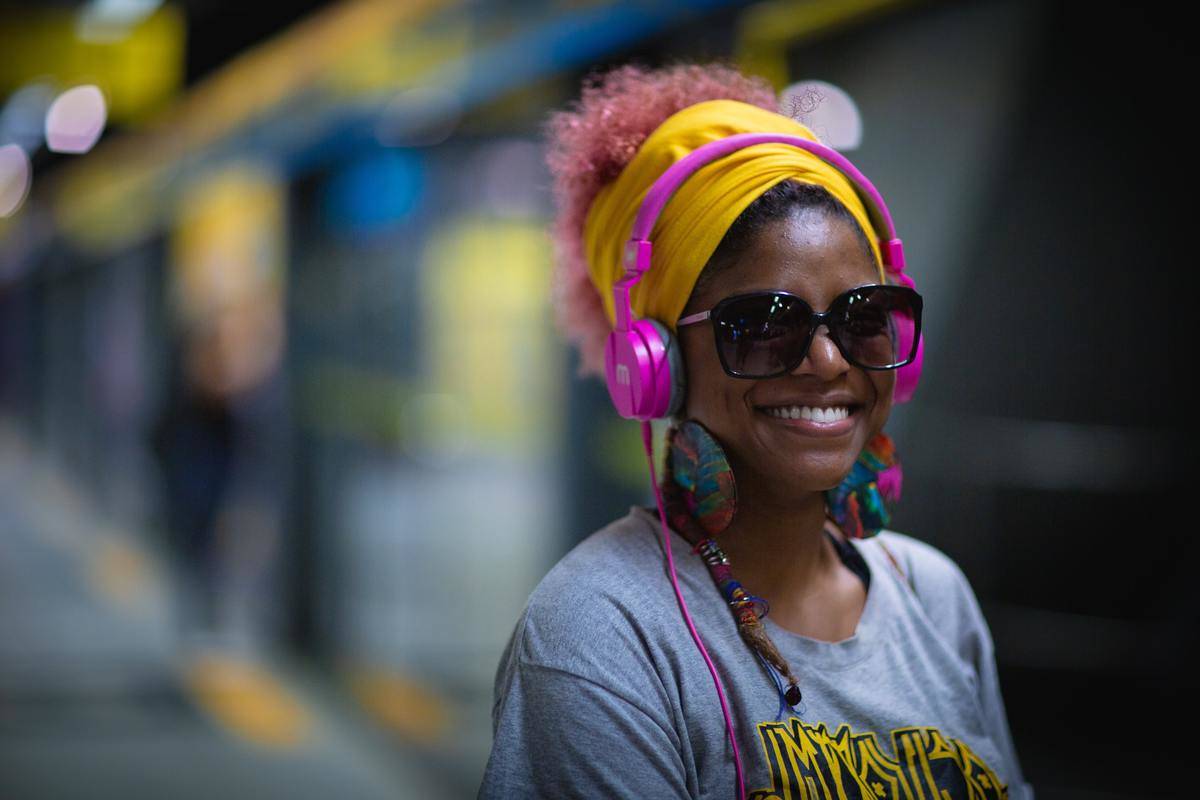 Woman smiling in sunglasses and headphones