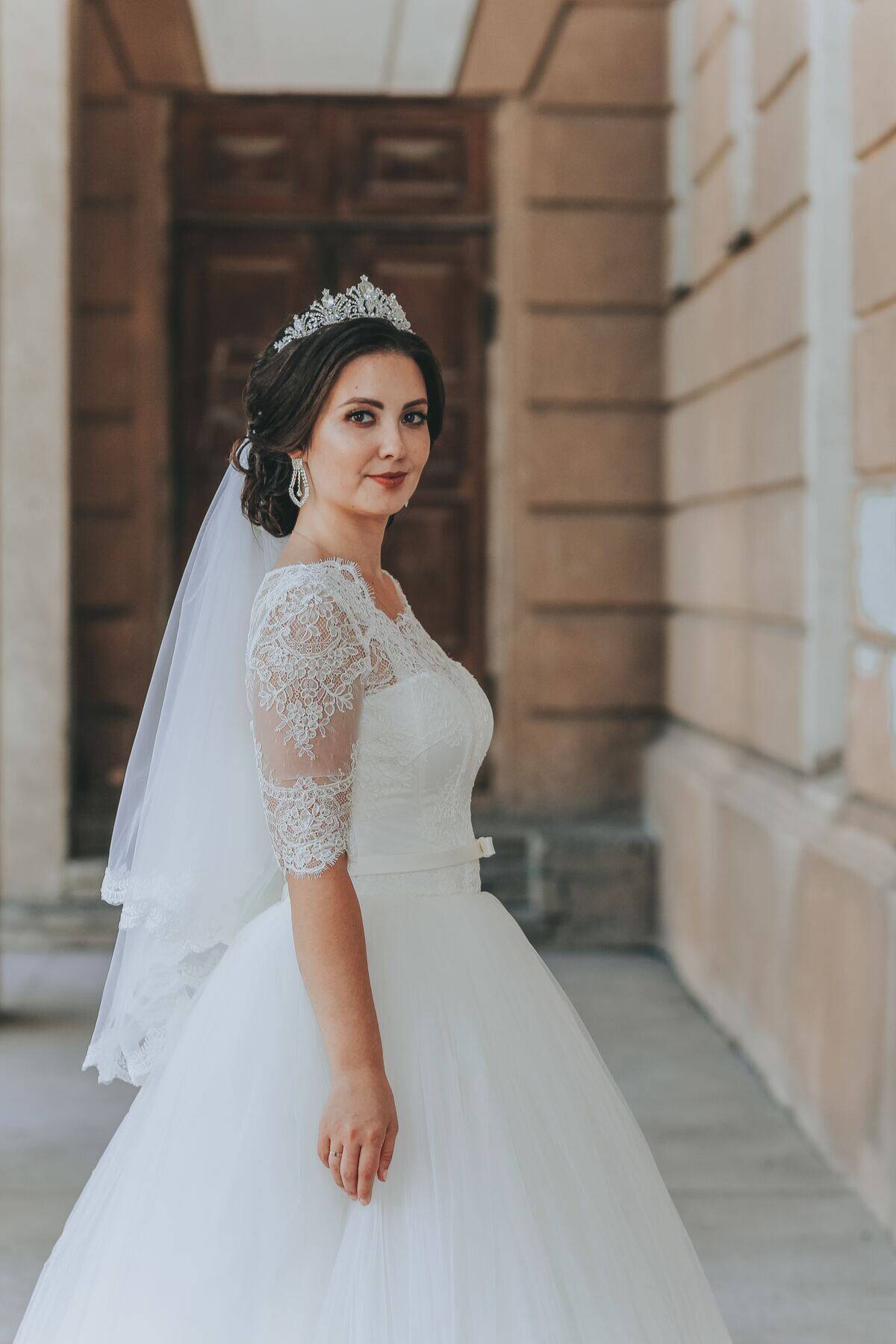 bride smiling subtly in front of door