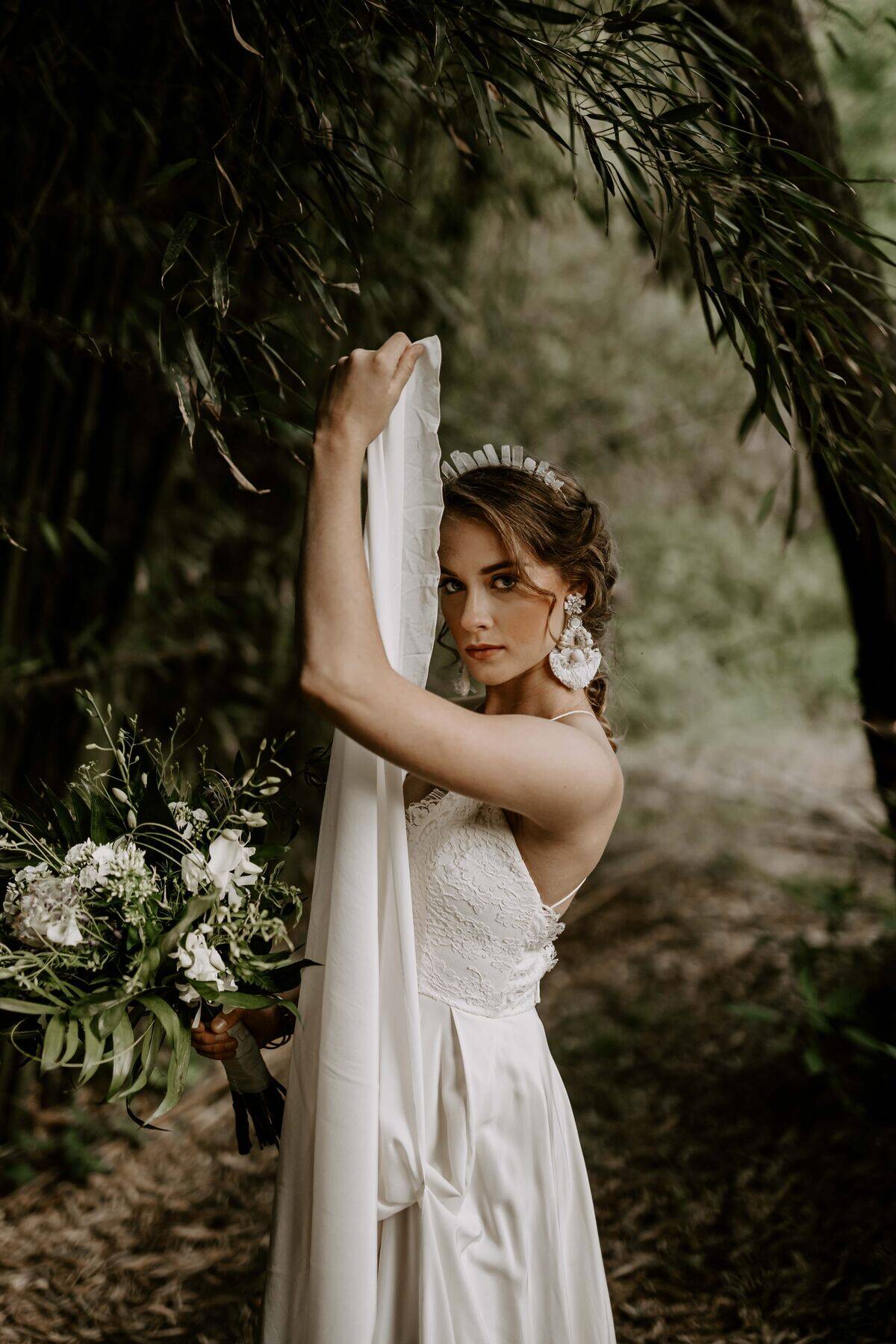 bride staring with serious face while lifting veil