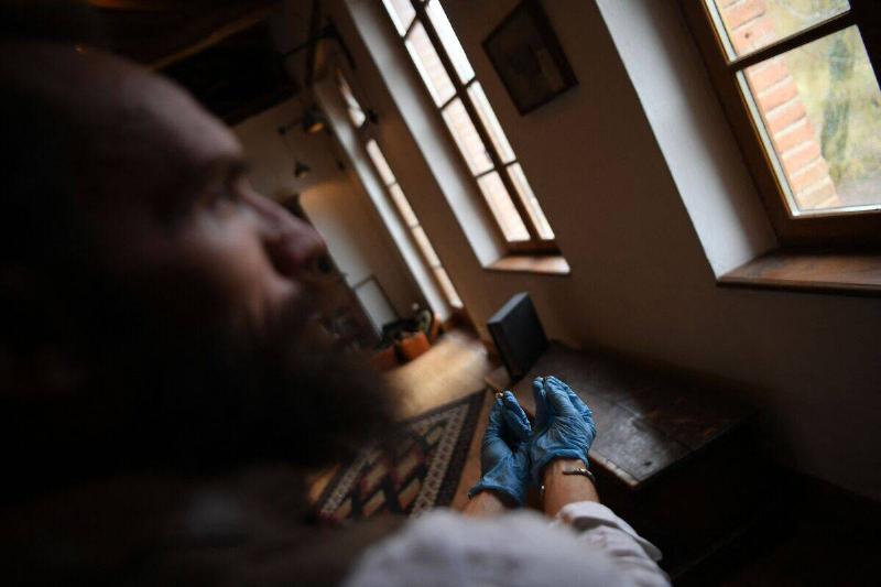Ludovic Slimak, French National Centre for Scientific Research (CNRS)  researcher and archaeologist of the University of Toulouse, poses with 
the milk teeth of a Homo Sapiens and a Neanderthal at his home in 
Saint-Laurent-sur-Save, southwestern France, on February 11, 2022.
