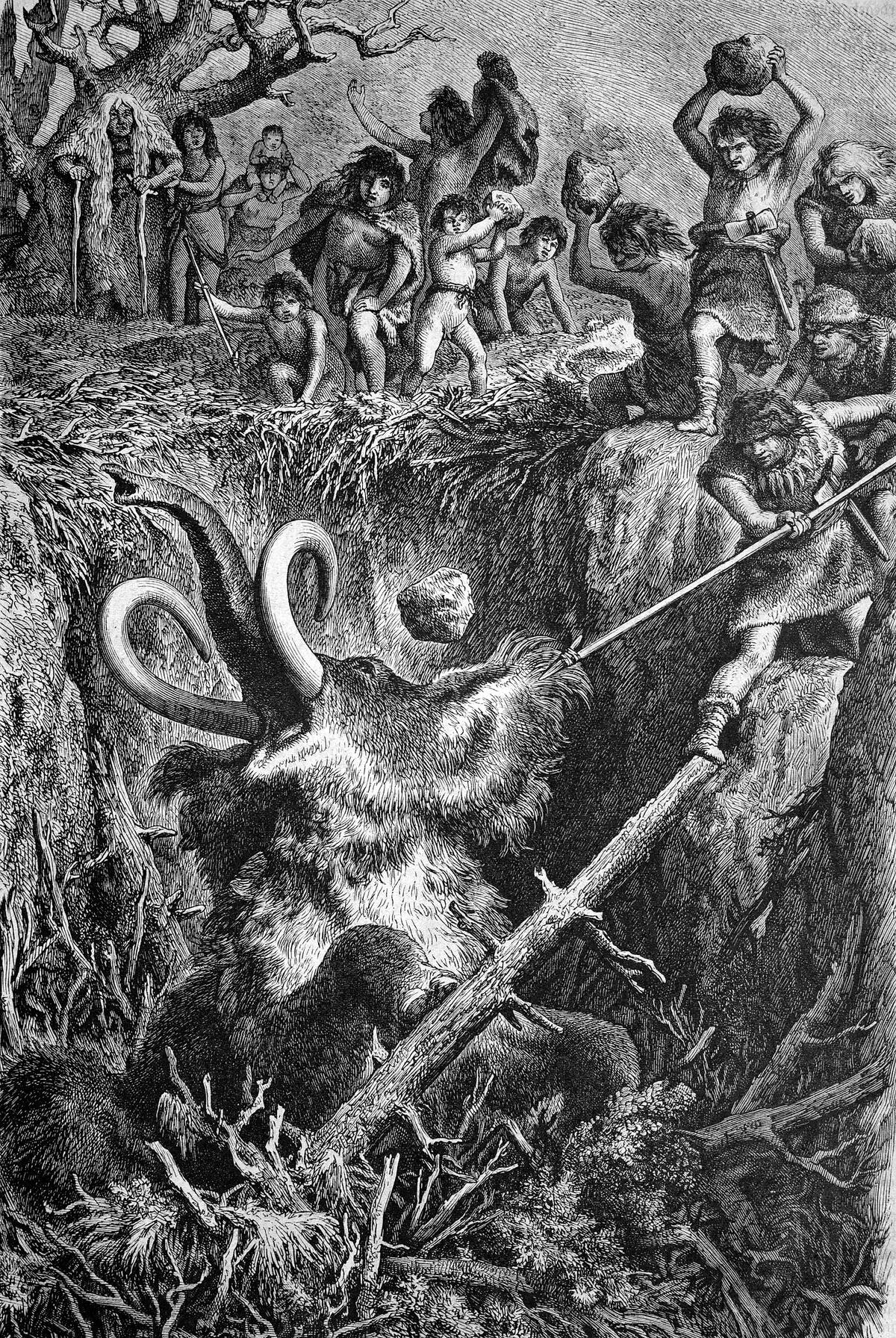 European cavemen hunting a mammoth, historic engraving of 1883