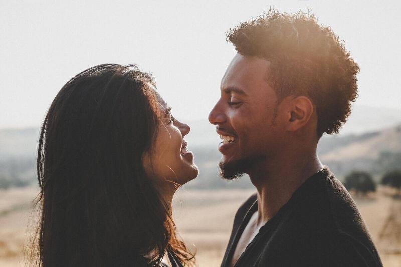 man and woman smiling close to each other's faces