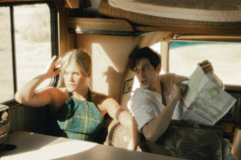 man with map looking shocked while woman ignores him in RV