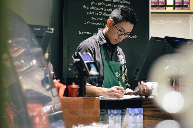 starbucks barista writing notes