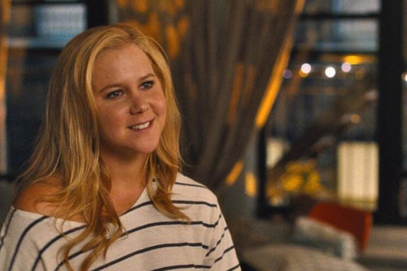 Amy Schumer smiling as Amy Townsend in Trainwreck