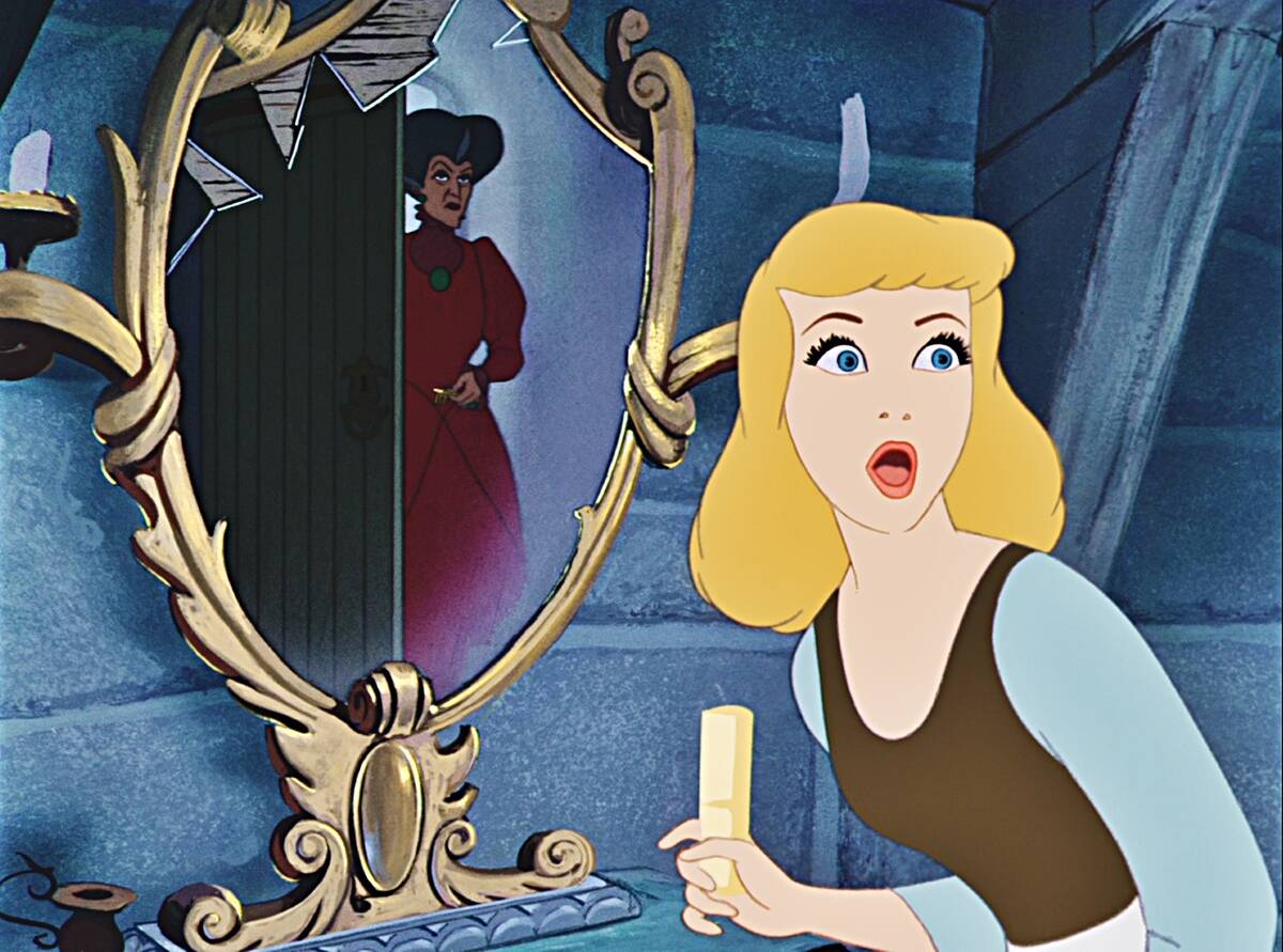 Cinderella looking in shock at mirror with evil stepmother in background