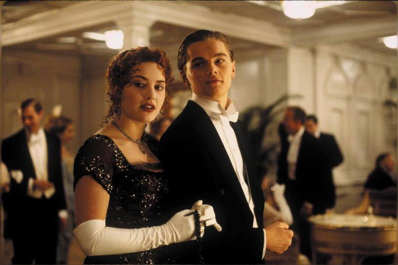 Leonardo DiCaprio and Kate Winslet standing in formal clothes as Jack Dawson and Rose DeWitt Bukater in Titanic