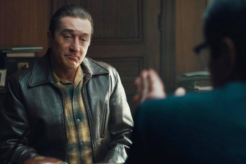 Robert Ne Niro sitting across from Ray Romano as frank Sheeran in The Irishman