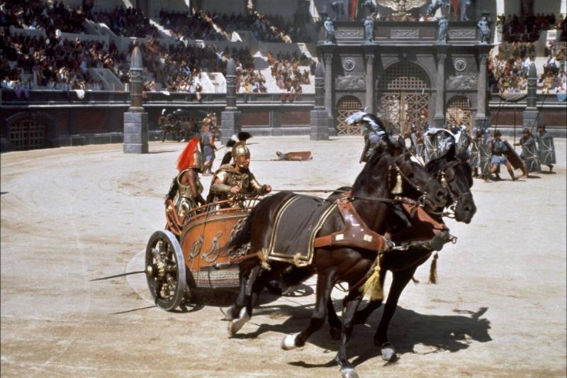 Roman centurions driving horse-drawn chariot in Collosseum in Gladiator