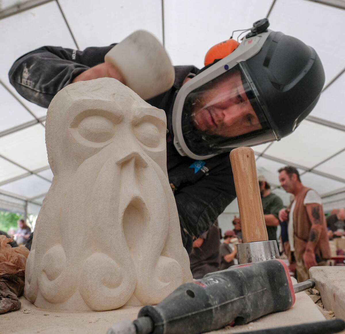 tonemason David Christison works on his piece 'Cthulhu' as he takes part in a stone carving festival at York Minster on August 19, 2018 in York, England.