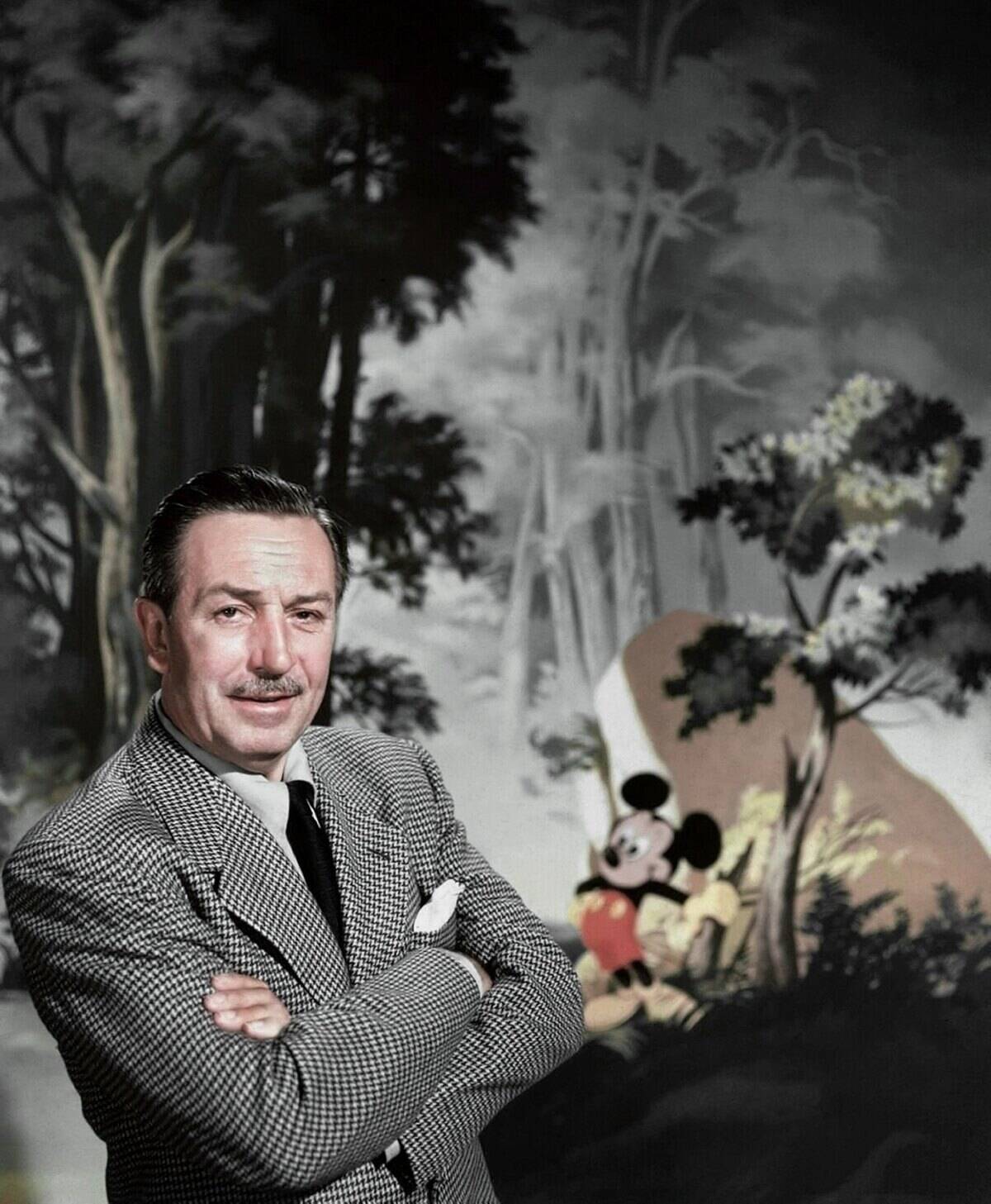 Entrepreneur Walt Disney poses for a portrait with Mickey Mouse in the background in circa 1955.