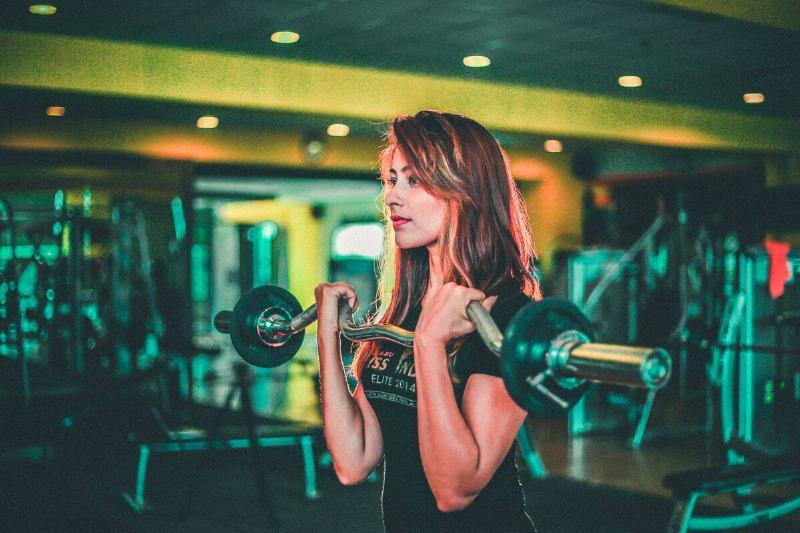 Woman lifting weight in gym