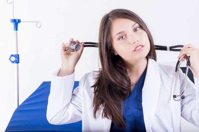 doctor holding stethoscope around neck