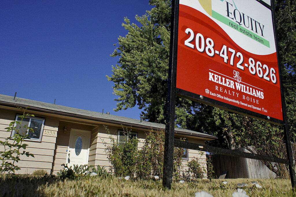 A sign sits outside a house that is bank-owned after being foreclosed in Boise, Idaho