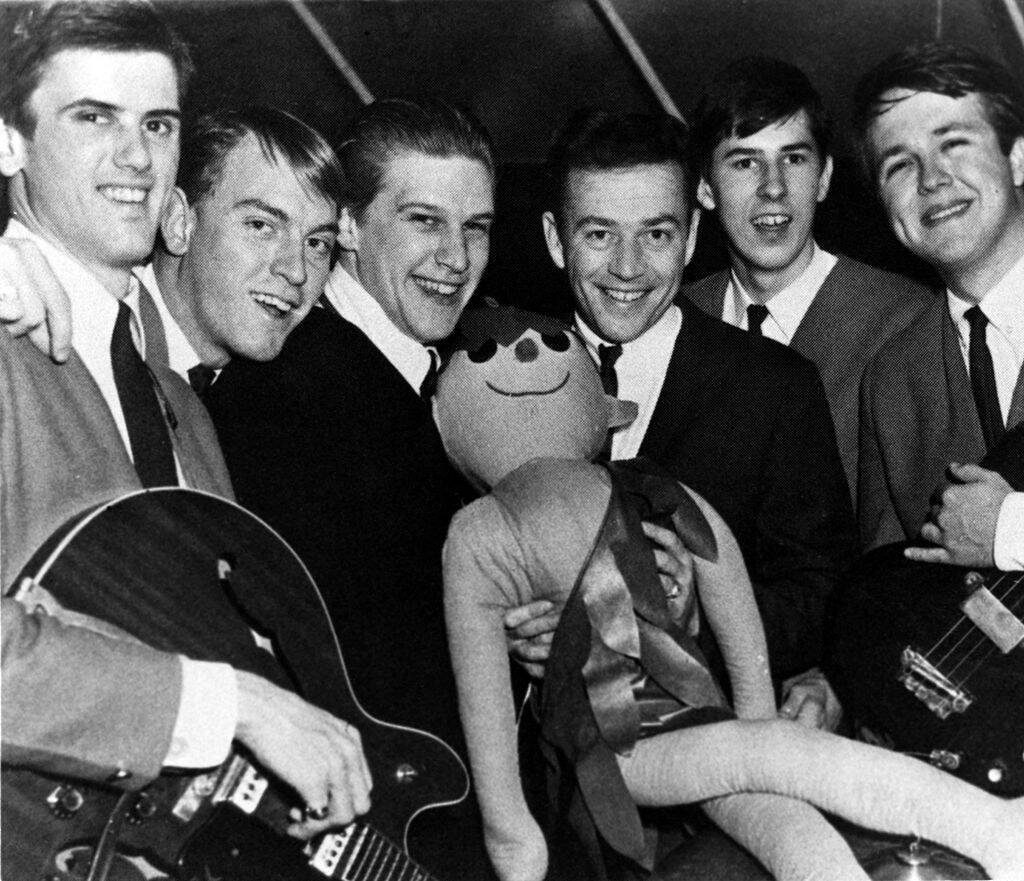 kingsmen holding a doll