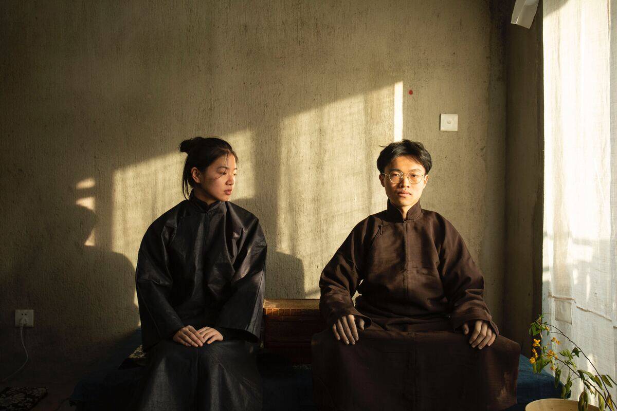 man staring intently as woman looks over at him