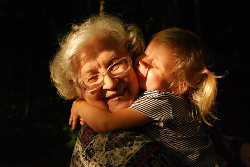 small child hugging grandmother