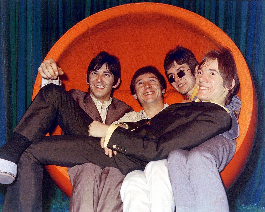 small faces sitting in an orange chair