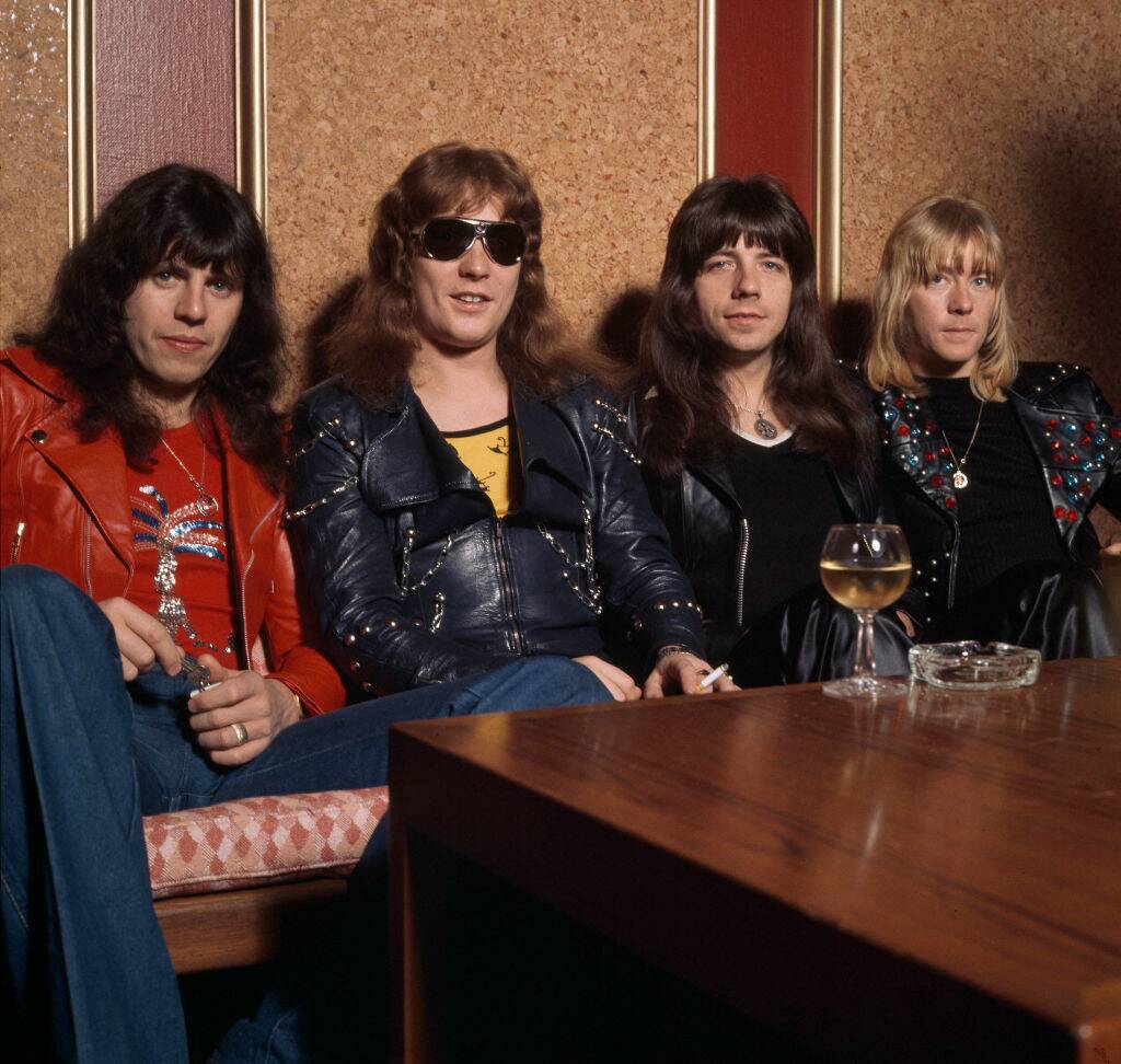 sweet band members posing for a photo