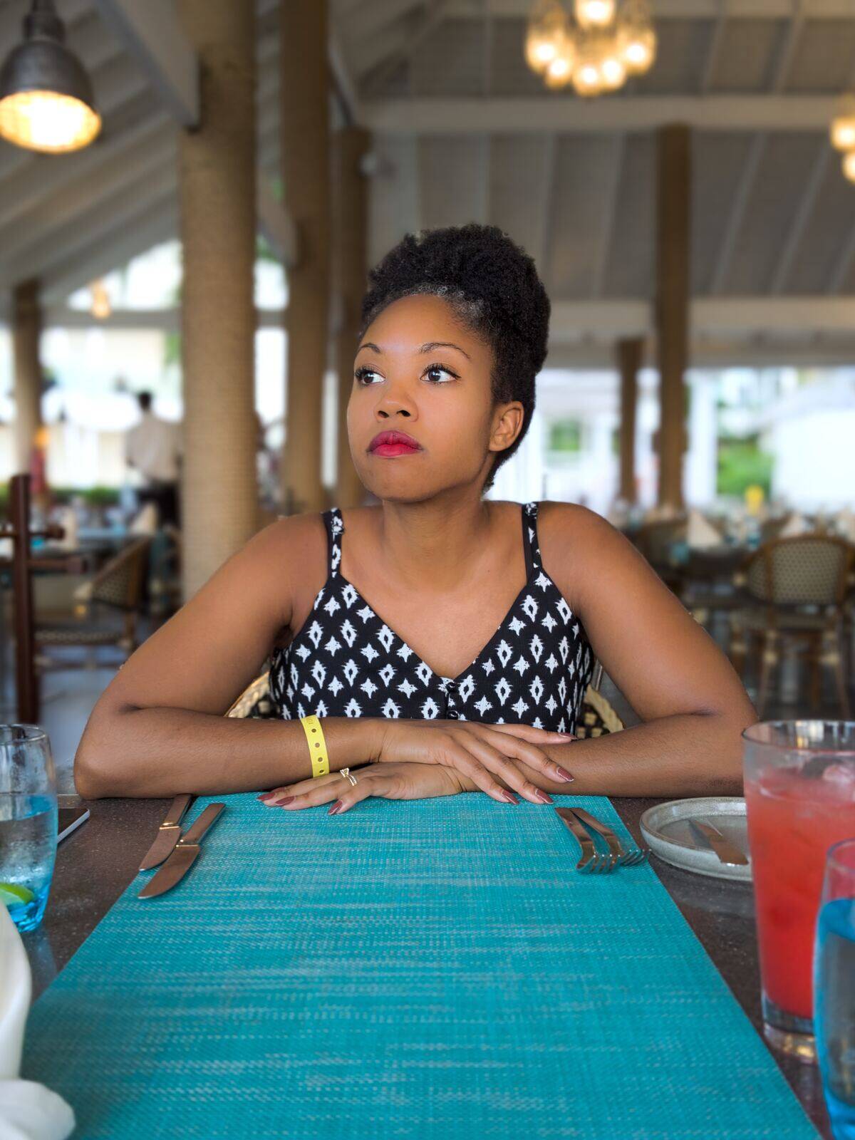 woman looking perturbed while sitting with table